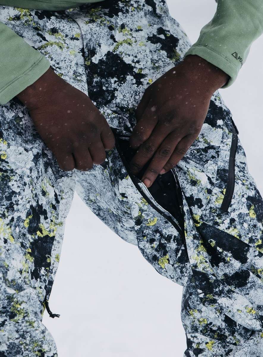 Burton AK GORE-TEX Cyclic Pant 2023 - Black snow pants with a subtle yellow pattern and white accents, featuring black zippers and a black drawstring.