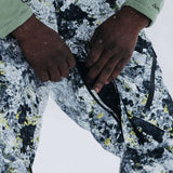 Burton AK GORE-TEX Cyclic Pant 2023 - Black snow pants with a subtle yellow pattern and white accents, featuring black zippers and a black drawstring.