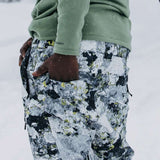 Burton AK GORE-TEX Cyclic Pant 2023 - Black snow pants with a subtle white and yellow pattern, featuring a zippered pocket on the side.