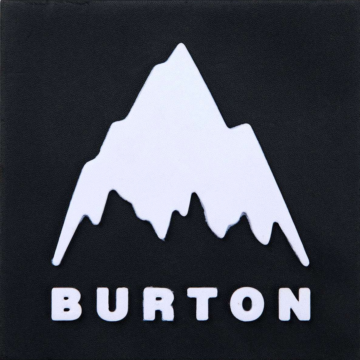 Burton Foam Mat Snowboard Stomp Pad 2023 - A white foam mat with a textured surface and a rectangular shape, featuring the word "BURTON" in black letters at one end.