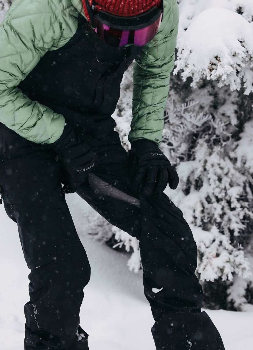 Burton Women's AK Gore-Tex Kimmy Bib Pant 2023 - Black bib pants with white logo on left leg, black straps and buckles.