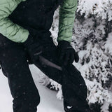 Burton Women's AK Gore-Tex Kimmy Bib Pant 2023 - Black bib pants with white logo on left leg, black straps and buckles.