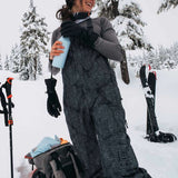 Burton Women's AK Gore-Tex Kimmy Bib Pant 2023 - Black snow pants with white dots and a black strap on the side.