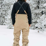 Burton Women's AK Gore-Tex Kimmy Bib Pant 2023 - Black bib with tan accents and black zippers on side pockets.