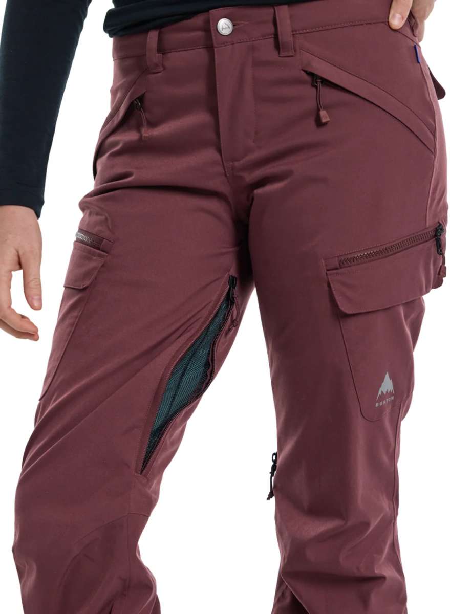 Burton Women's Gloria 2 Layer Stretch Pant 2024 - A pair of burgundy ski pants with a zippered pocket on the side and a small white logo near the bottom right leg.