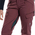 Burton Women's Gloria 2 Layer Stretch Pant 2024 - A pair of burgundy ski pants with a zippered pocket on the side and a small white logo near the bottom right leg.