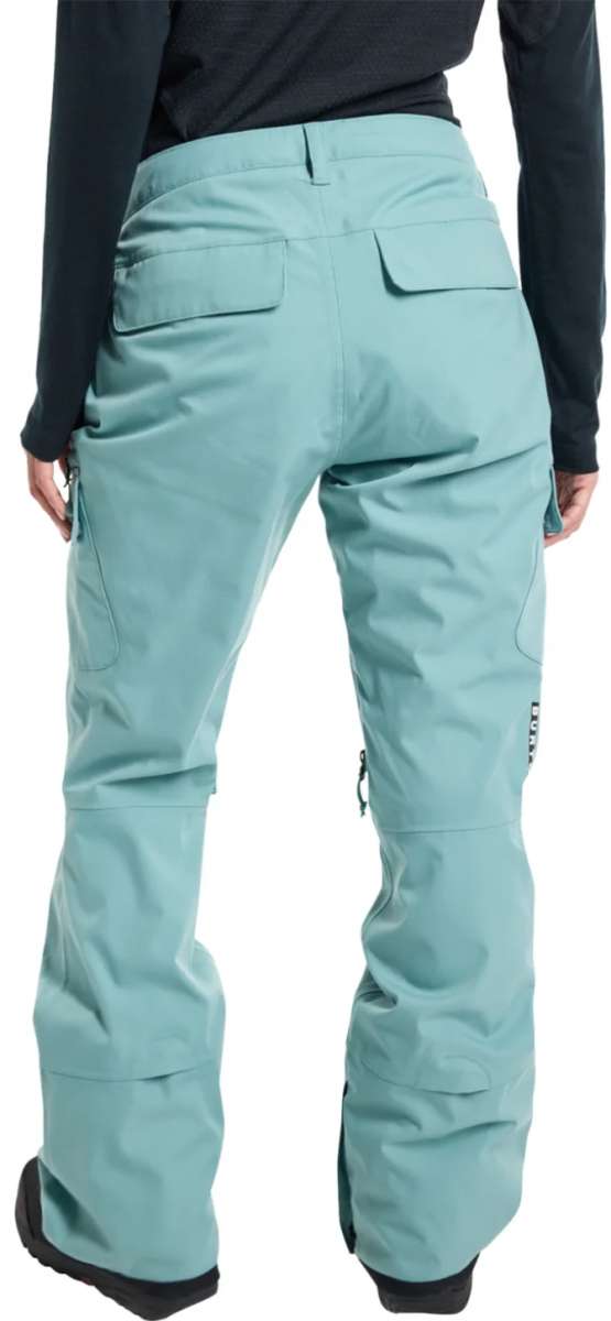 Burton Women's Gloria 2 Layer Stretch Pant 2024 - A pair of light blue snow pants with a black logo on the left thigh and a zippered pocket on the right hip.