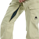 Burton Women's Gloria 2 Layer Stretch Pant 2024 - A pair of khaki-colored snow pants with a zippered pocket on the thigh and a black zipper running down the side.