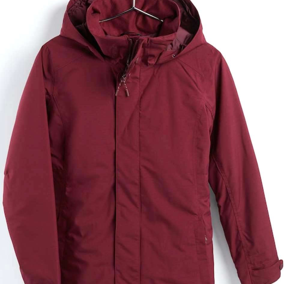 Burton Women's Jet Set insulated Jacket - A burgundy jacket with a hood, featuring a zipper and snap buttons down the front.