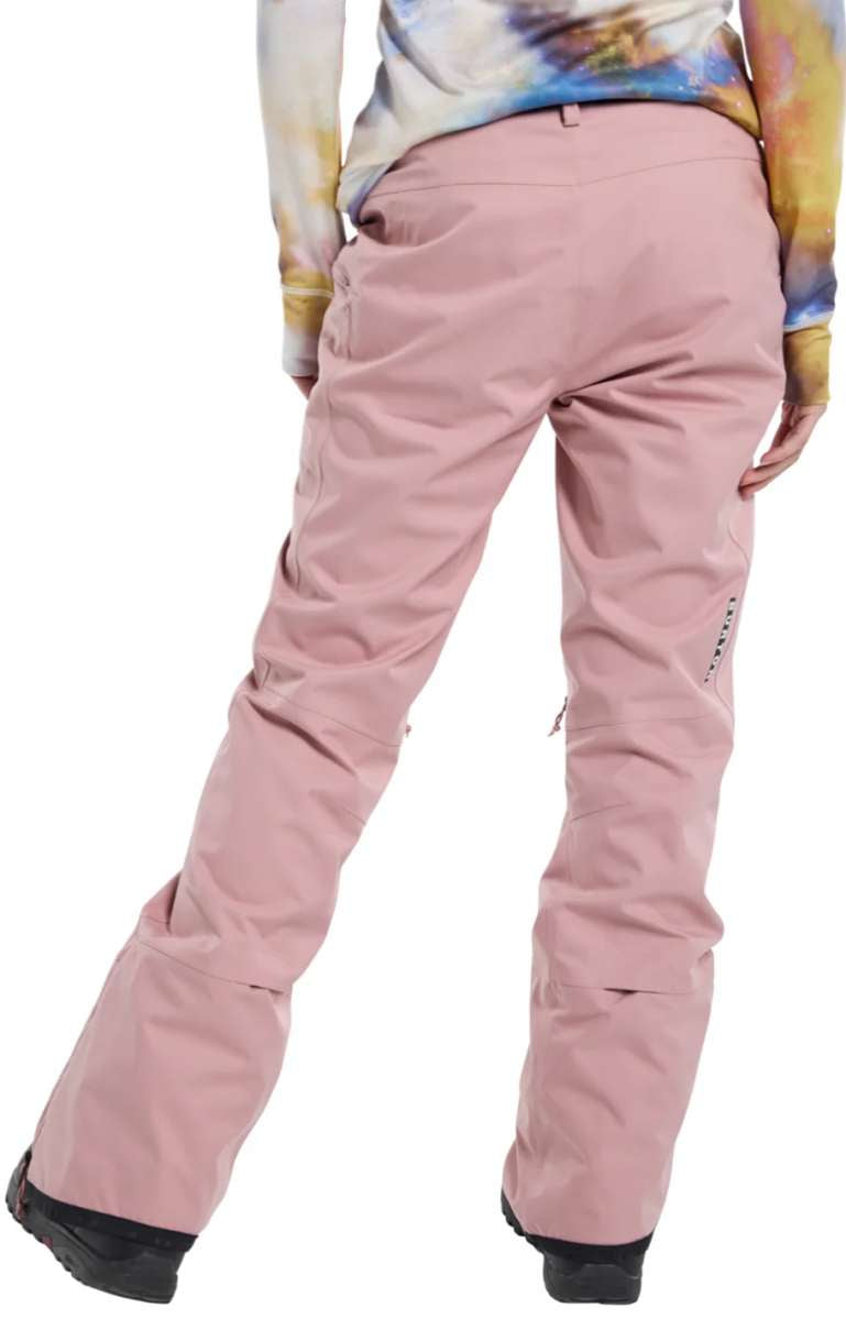 Burton Women's Marcy High Rise Stretch Pants 2024 - A pair of high-rise, pink snow pants with a subtle pattern and black accents on the side pockets.