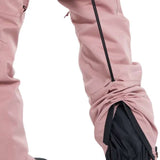 Burton Women's Marcy High Rise Stretch Pants 2024 - A pair of dusty rose-colored snow pants with a black zipper on the left leg and a white "BURTON" logo on the right thigh.