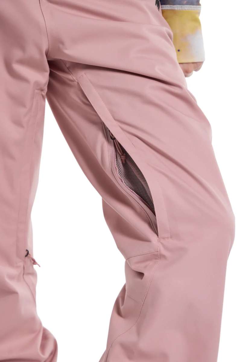 Burton Women's Marcy High Rise Stretch Pants 2024 - A pair of high-rise, pink ski pants with a zippered pocket on the side and adjustable cuffs at the bottom.