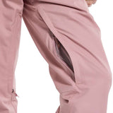 Burton Women's Marcy High Rise Stretch Pants 2024 - A pair of high-rise, pink ski pants with a zippered pocket on the side and adjustable cuffs at the bottom.