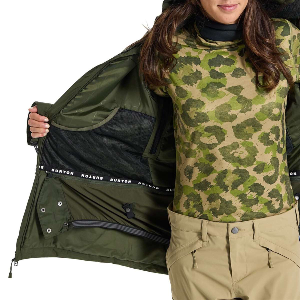 Burton Women's Pillowline GORE-TEX Insulated Jacket 2024 - A green and tan camouflage patterned jacket with a black zipper and white lettering on the sleeve cuff.