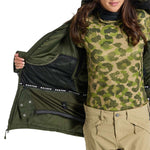 Burton Women's Pillowline GORE-TEX Insulated Jacket 2024 - A green and tan camouflage patterned jacket with a black zipper and white lettering on the sleeve cuff.