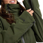 Burton Women's Pillowline GORE-TEX Insulated Jacket 2024 - A dark green jacket with a high collar and zippered pockets, featuring a black zipper on the chest.