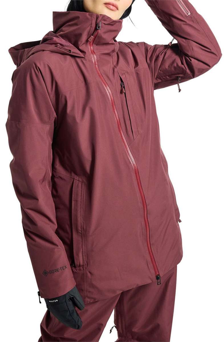 Burton Women's Pillowline GORE-TEX Insulated Jacket 2024 - A burgundy jacket with a hood and black zipper, featuring a GORE-TEX logo on the left sleeve.