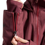 Burton Women's Pillowline GORE-TEX Insulated Jacket 2024 - A woman's jacket with a burgundy color and black zipper, featuring a diamond-shaped logo on the left sleeve.