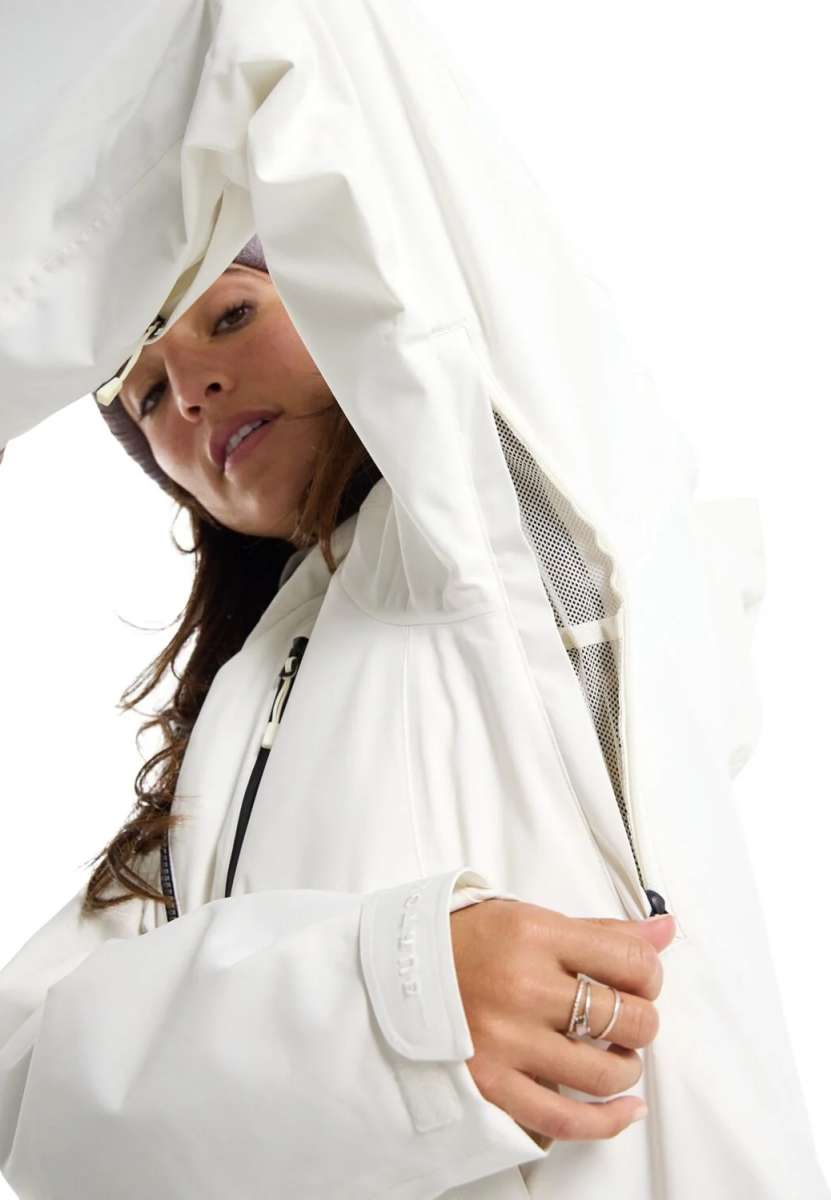 Burton Women's Pyne 2L Shell Jacket 2024 - A white jacket with a hood, featuring black zippers and a mesh material on the inside of the hood.