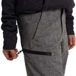Burton Youth Exile 2L Insulated Cargo Pant 2024 - A pair of gray cargo pants with a zippered pocket on the thigh and a black zipper pull.