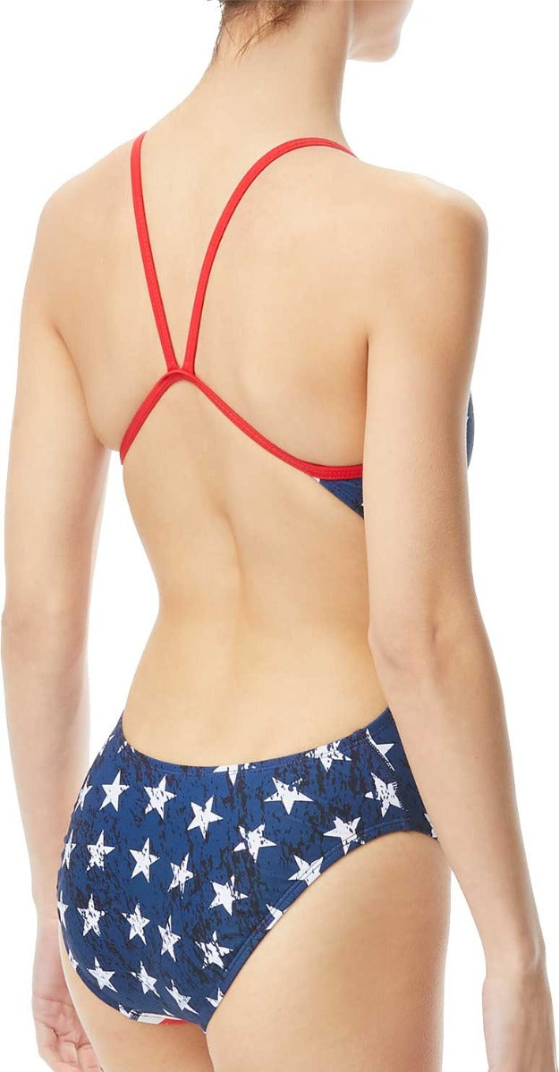 TYR Ladies' Star Spangled Cutoutfit Swimsuit - A navy blue swimsuit with white stars and red trim, featuring cutouts on the sides.