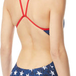 TYR Ladies' Star Spangled Cutoutfit Swimsuit - A navy blue swimsuit with white stars and red trim, featuring cutouts on the sides.