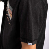 Coal Baker Short Sleeve Tee 2023 - A black t-shirt with a white graphic of two wolves' heads facing each other on the front.