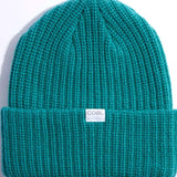 Coal Dan Mid Length Beanie 2023 - A teal beanie with a white label featuring the word "COAL" in black letters.