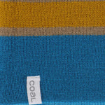 Coal Speed Demon Tall Beanie 2023 - A blue beanie with a tan stripe and gray lettering on the front.