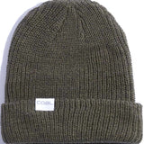 Coal Stanley Mid Length Beanie 2023 - A dark green beanie with a ribbed texture and folded cuff, featuring a small white rectangular label on the front that reads "COAL" in blue letters.