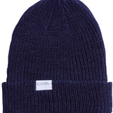 Coal Stanley Mid Length Beanie 2023 - A navy blue beanie with a white rectangular label on the front that says "COAL" in gray letters.