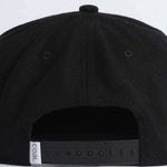 Coal Uniform Cap 2023 - Black cap with a small embroidered logo on the front, featuring a solid color design and a flat brim.