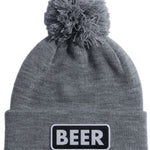 Coal Vice Mid Length Pom Beanie 2023 - A gray beanie with a large, fluffy pom-pom on top and a black patch that says "BEER" in white letters.