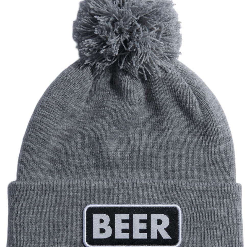 Coal Vice Mid Length Pom Beanie 2023 - A gray beanie with a large, fluffy pom-pom on top and a black patch that says "BEER" in white letters.