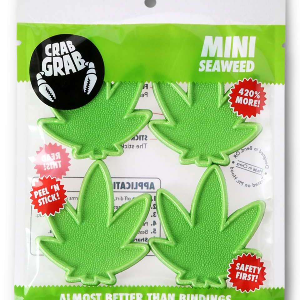 Crab Grab Mini Seaweed Stomp Pad 2024 - Green seaweed-shaped pad with a textured surface and a small, circular logo on top.