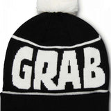 Crab Grab Pom Beanie 2022-2023 - A black beanie with a white pom-pom on top and "CRAB GRAB" embroidered in white across the front.