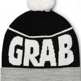 Crab Grab Pom Beanie 2022-2023 - A black beanie with a white pom-pom on top and "CRAB GRAB" embroidered in white across the front.