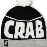 Crab Grab Pom Beanie 2022-2023 - A black beanie with a white pom-pom on top and "CRAB GRAB" embroidered in white across the front.