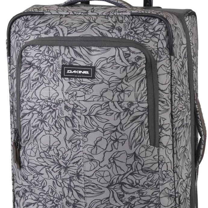 Dakine Carry-On Roller 42L Bag - A gray roller bag with a floral pattern and black trim, featuring a handle on top and two wheels at the bottom.