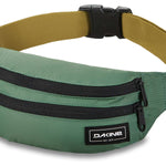 Dakine Classic Hip Pack 2023 - A green hip pack with two zippered pockets and a black zipper pull on one pocket.