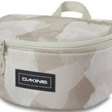 Dakine Goggle Stash - A tan-colored bag with a zippered top and handle, featuring a geometric pattern on its front.
