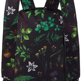 Dakine Ladies Essentials Pack 7L 2022-2023 - A black backpack with a repeating pattern of green leaves and purple flowers.