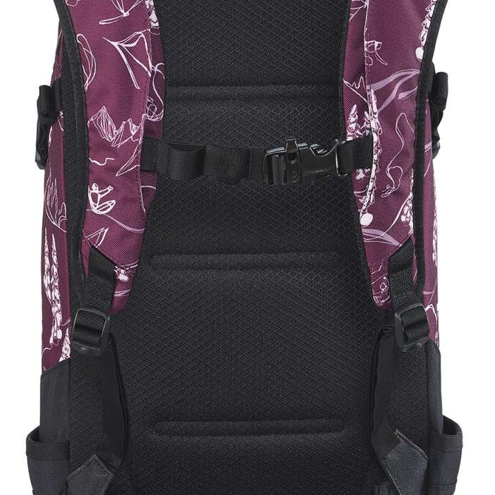 Dakine Ladies Heli Pro 20L Backpack - A purple backpack with white floral pattern and black accents, featuring a zippered front pocket and adjustable straps.