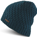 Dakine Ladies Zoe Beanie 2024 - A dark teal beanie with a ribbed cuff and a small brown leather label on the front.