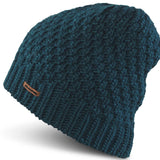 Dakine Ladies Zoe Beanie 2024 - A dark teal beanie with a ribbed cuff and a small brown leather label on the front.