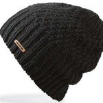 Dakine Ladies Zoe Beanie 2024 - A black beanie with a small, rectangular brown leather tag on the front.