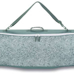 Dakine - Pipe Board Bag 2024 is shown in a light gray color with a subtle floral pattern on its front side.