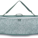 Dakine - Pipe Board Bag 2024 is shown in a light gray color with a subtle floral pattern on its front side.