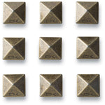 Dakine Pyramid Stud Stomp Pad 2024 - A pyramid-shaped metal stud with a flat top and rounded edges, featuring a bronze-colored finish.