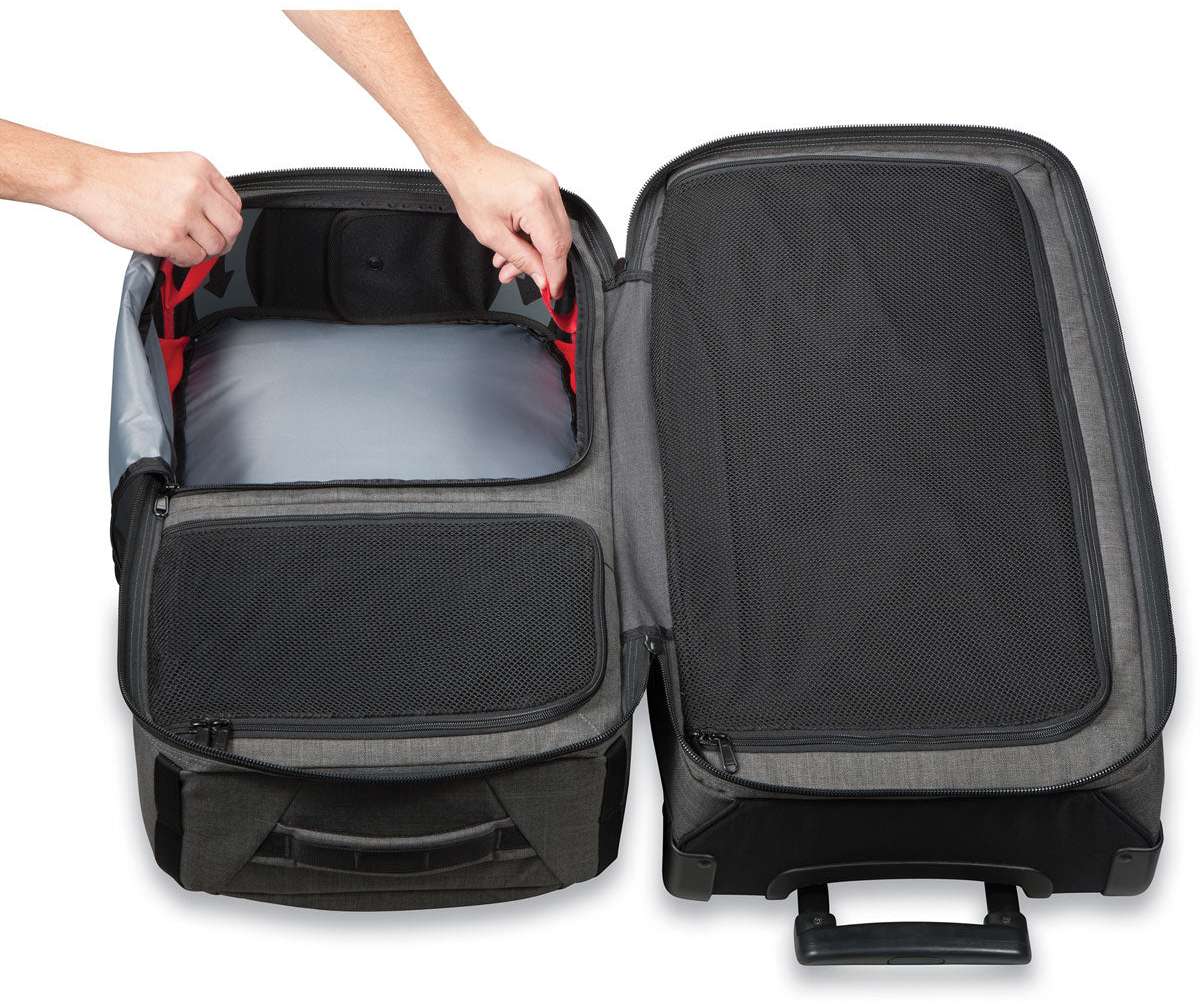 Dakine Split Roller 85L 2022-2023 - Black roller bag with red zipper pulls and black wheels.
